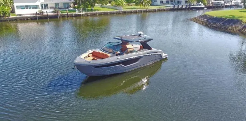  Yacht Photos Pics 2023 Cruisers Yachts 38 GLS on a serene waterway, showcasing sleek design and luxury features.