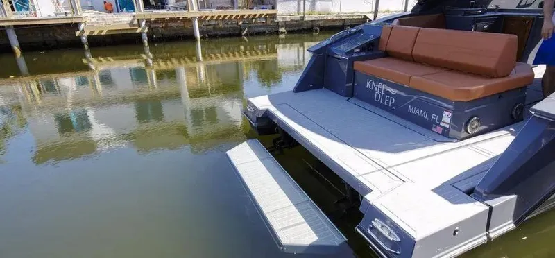  Yacht Photos Pics 2023 Cruisers Yachts 38 GLS with swim platform, docked in calm waters.