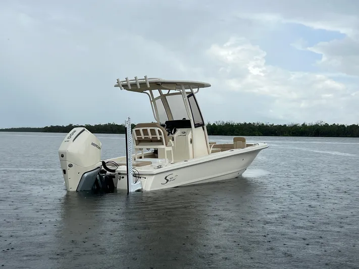  Yacht Photos Pics 2025 Scout 231 XSB boat on calm water under cloudy sky.