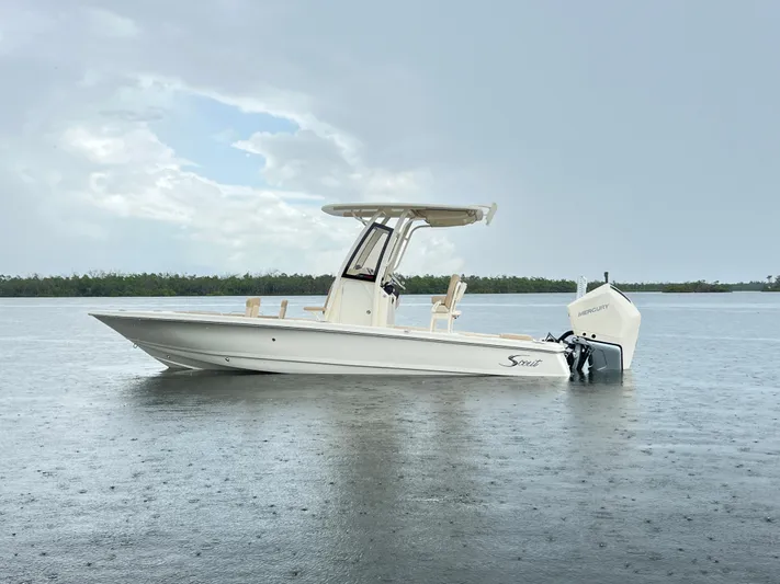  Yacht Photos Pics 2025 Scout 231 XSB boat on calm water under cloudy sky.