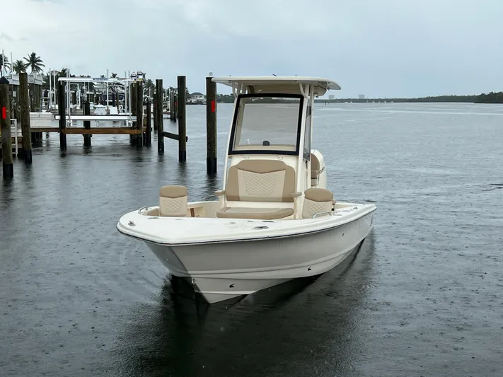  Yacht Photos Pics 2025 Scout 231 XSB boat on water near docks, overcast sky.