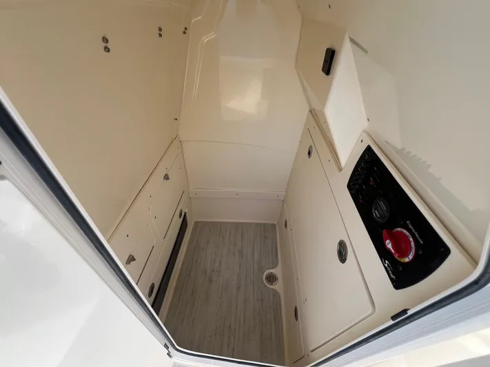  Yacht Photos Pics Interior of 2025 Scout 231 XSB boat, featuring storage compartments and control panel.