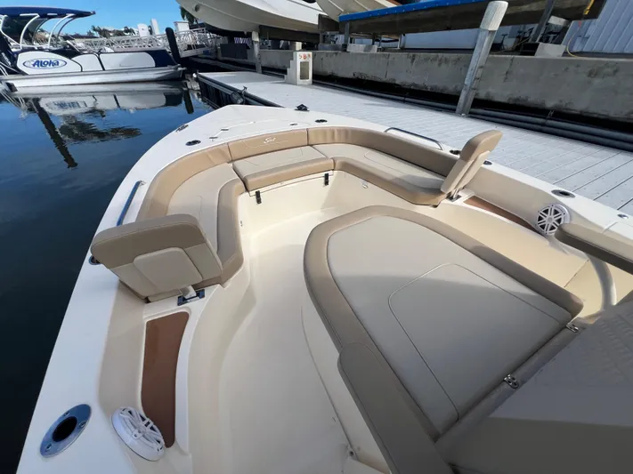  Yacht Photos Pics 2025 Scout 231 XSB boat interior with beige seating at a marina.