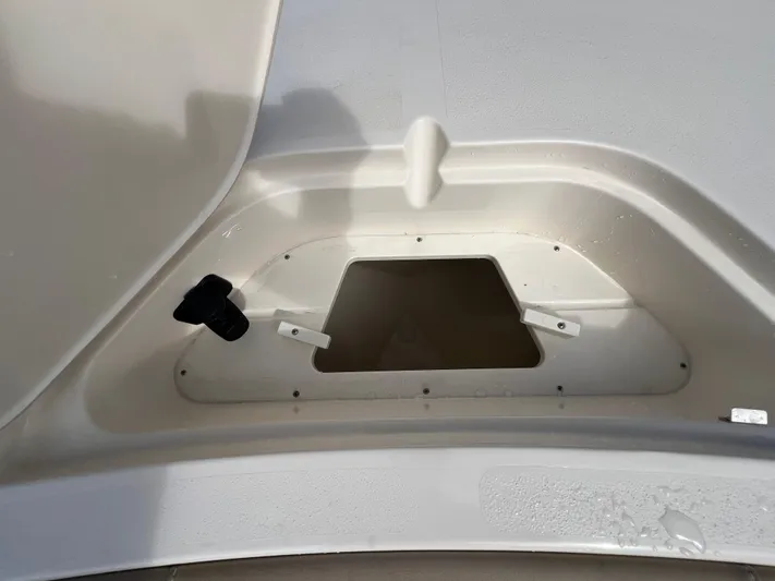  Yacht Photos Pics 2025 Scout 231 XSB boat compartment with open hatch and visible latch mechanism.