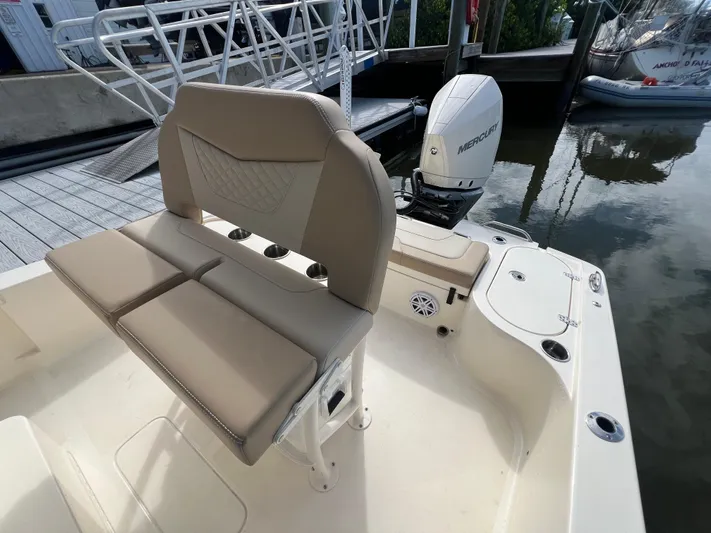  Yacht Photos Pics 2025 Scout 231 XSB boat interior with seating and Mercury outboard motor at dock.