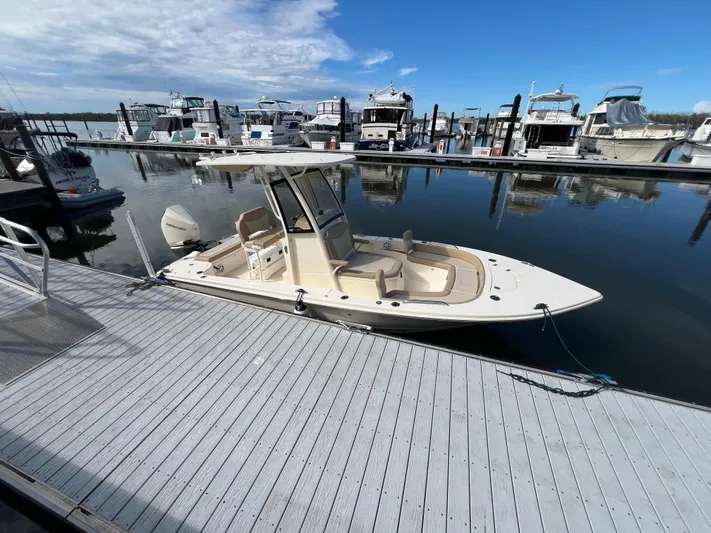  Yacht Photos Pics 2025 Scout 231 XSB boat docked at marina under clear blue sky.