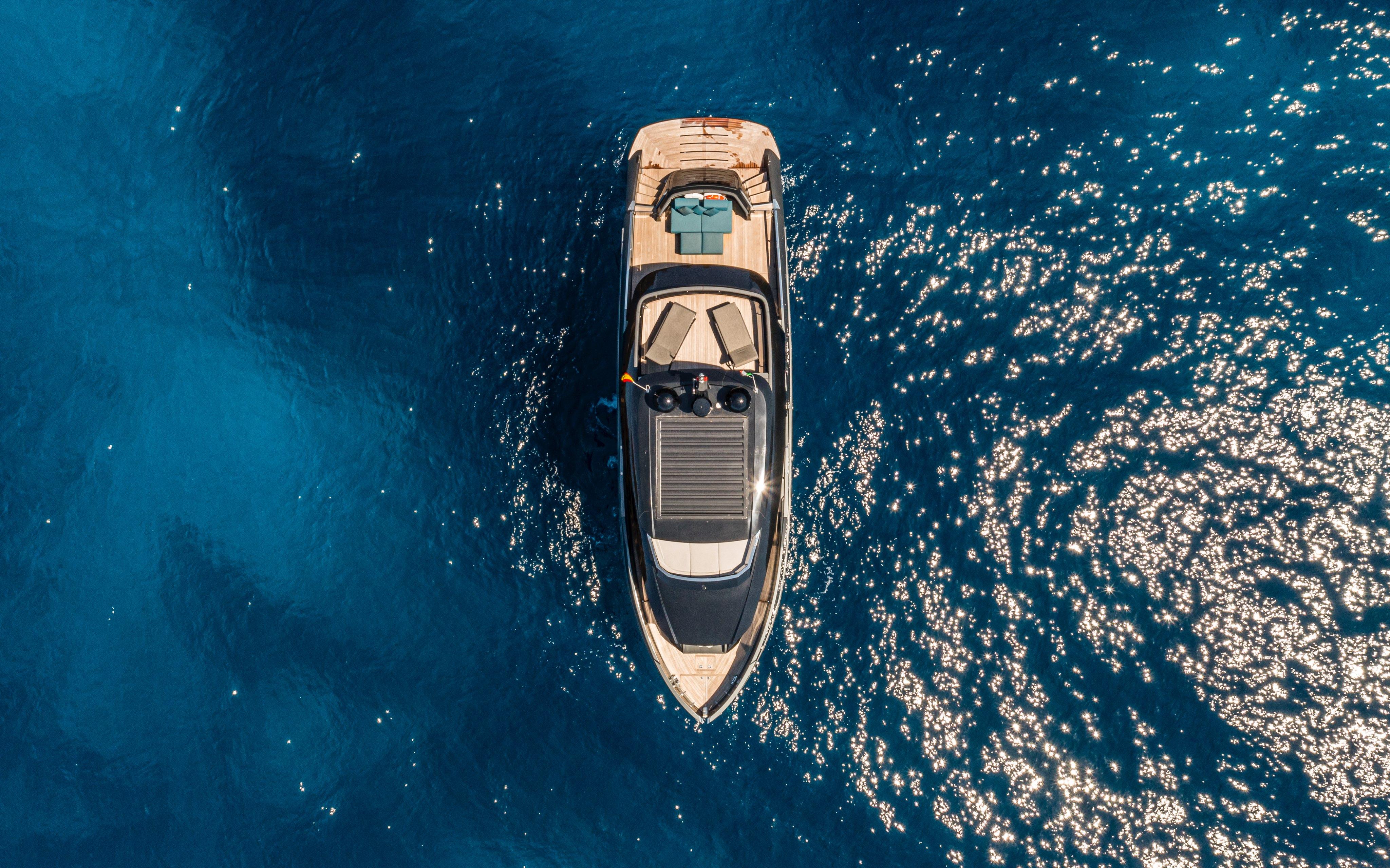Aerial view of 2025 Explorer 62 yacht on sparkling blue ocean.