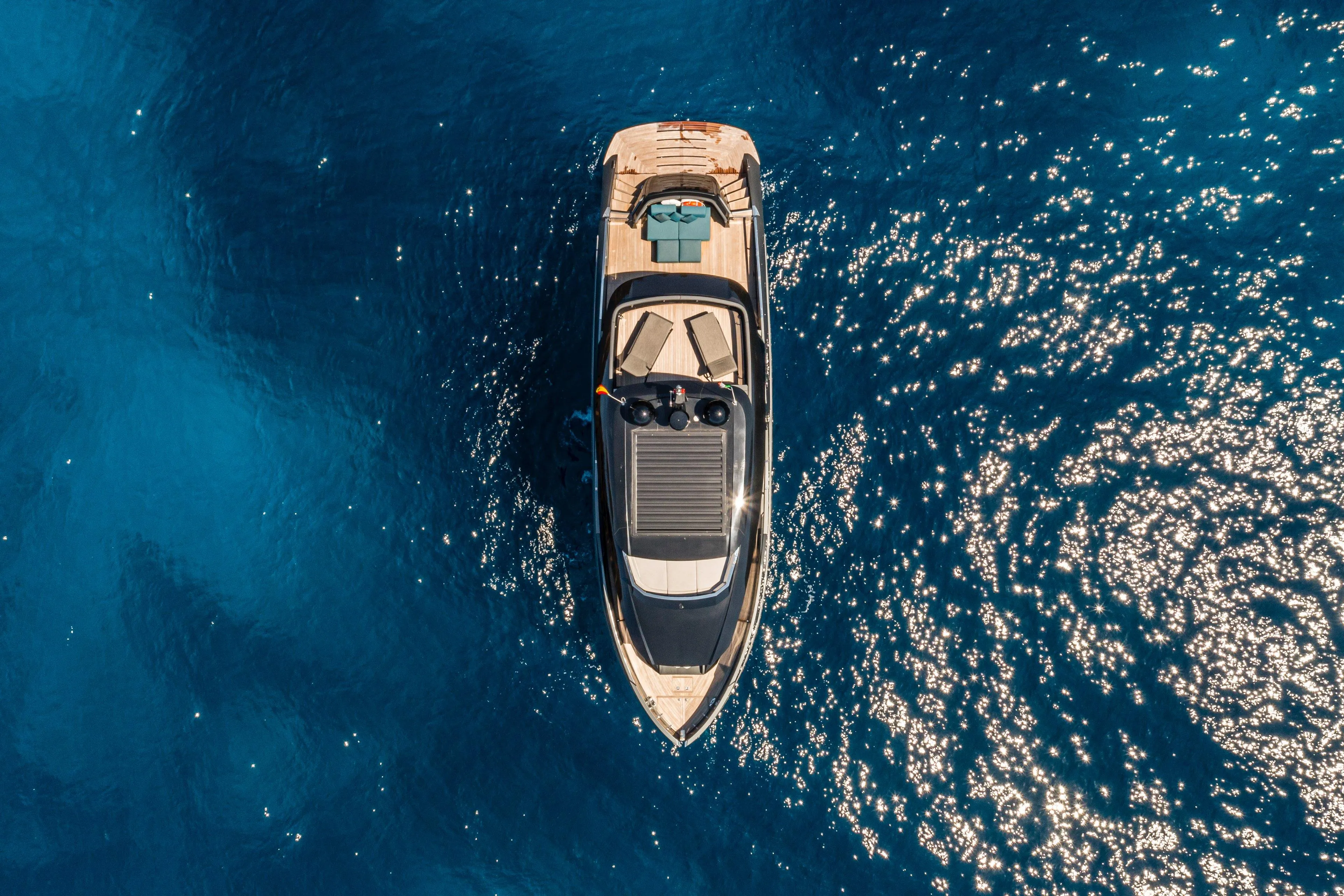 Aerial view of 2025 Explorer 62 yacht on sparkling blue ocean.