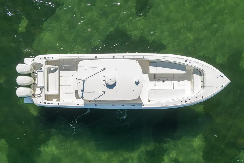  Yacht Photos Pics Aerial view of 2015 Intrepid 400 Center Console boat on clear green water.