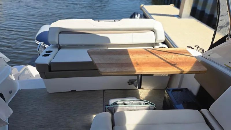  Yacht Photos Pics 2017 Regal 32 Express boat interior with seating and wooden table by the water.