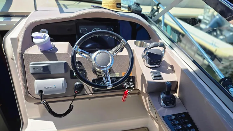  Yacht Photos Pics Cockpit of 2017 Regal 32 Express boat with steering wheel and navigation controls.