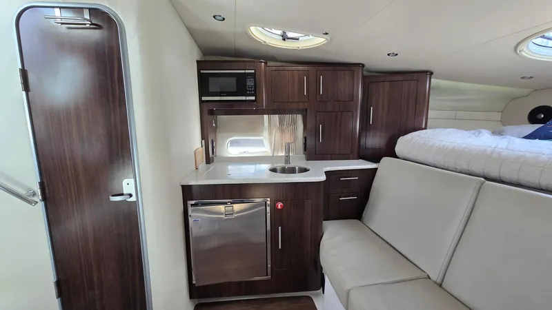  Yacht Photos Pics 2017 Regal 32 Express interior with kitchenette, seating, and bed. Modern yacht cabin design.