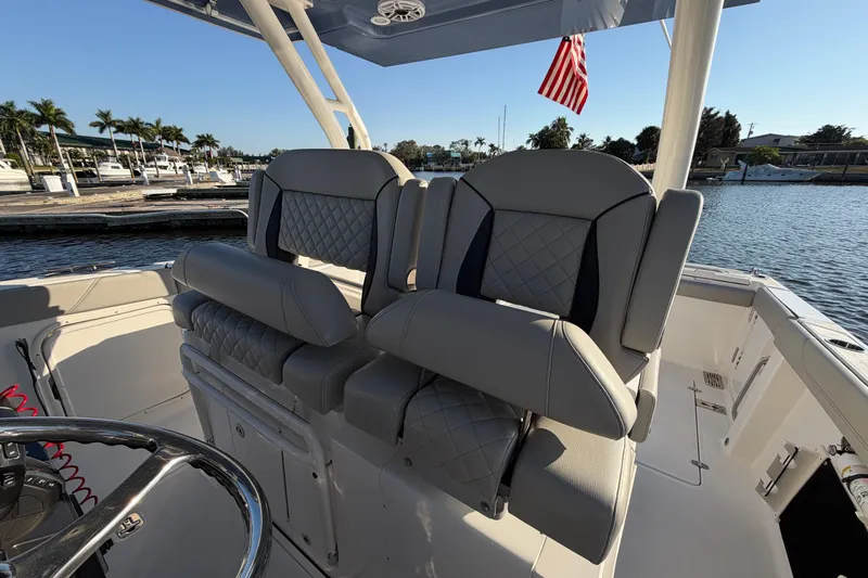  Yacht Photos Pics 2023 Pursuit S 328 Sport boat interior with luxurious seating and waterfront view.