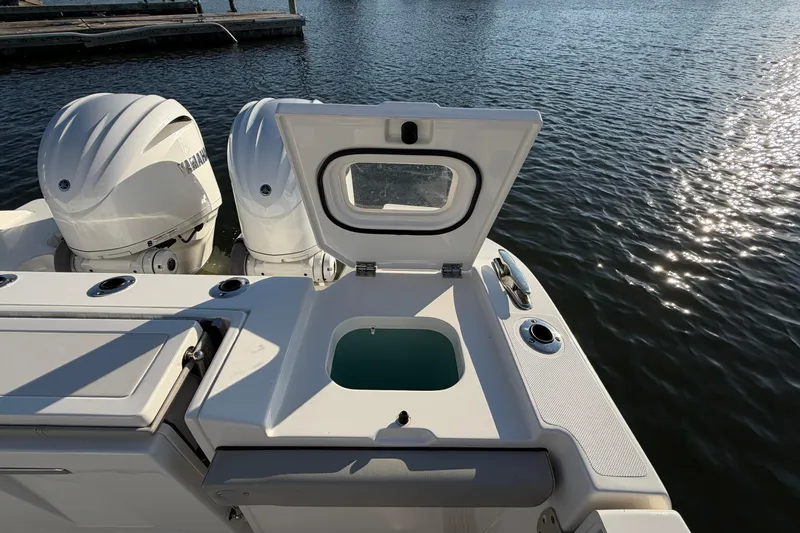  Yacht Photos Pics 2023 Pursuit S 328 Sport boat with open hatch and twin engines on water.