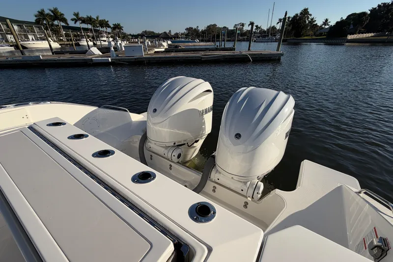  Yacht Photos Pics 2023 Pursuit S 328 Sport boat with dual outboard engines docked at marina.