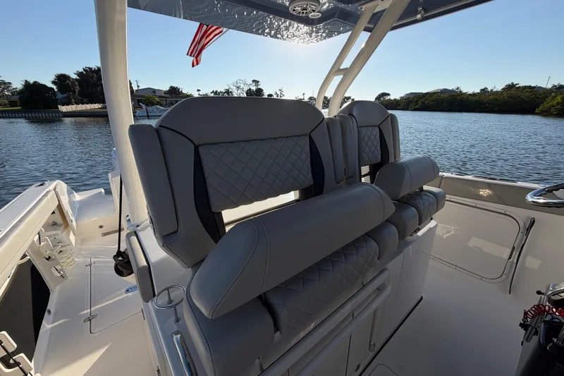  Yacht Photos Pics 2023 Pursuit S 328 Sport boat interior with luxurious seating and scenic water view.