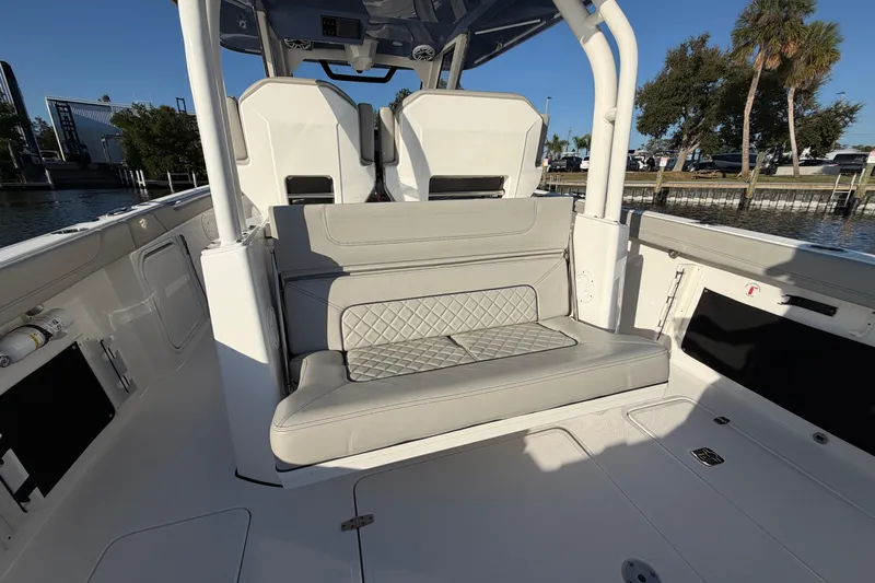  Yacht Photos Pics 2023 Pursuit S 328 Sport boat interior with cushioned seating and modern design.