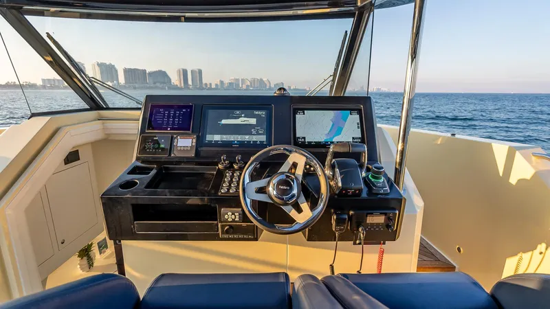  Yacht Photos Pics Helm of 2025 Fabbro F45 CABRIO yacht with advanced navigation systems, overlooking ocean and city skyline.