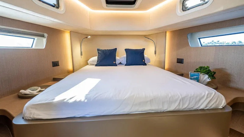  Yacht Photos Pics Luxurious cabin interior of 2025 Fabbro F45 CABRIO yacht with cozy bed and modern lighting.