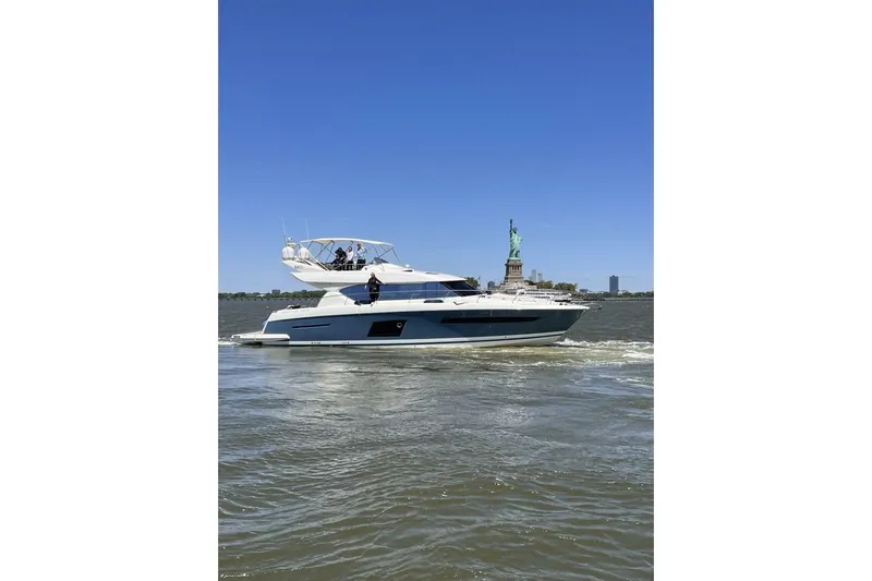 Blue Haven Yacht Photos Pics Prestige 620S yacht cruising near Statue of Liberty, clear blue sky, 2014 model.