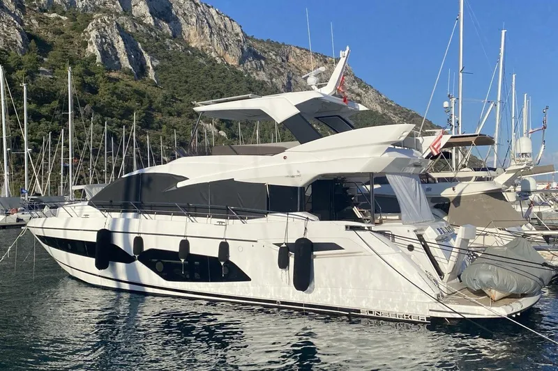  Yacht Photos Pics 2019 Sunseeker Manhattan 66 yacht docked in a scenic marina.