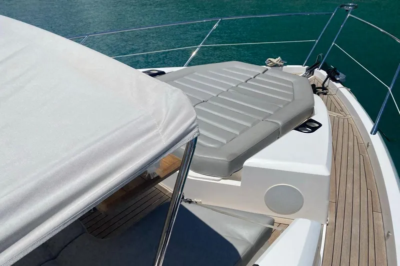  Yacht Photos Pics 2019 Sunseeker Manhattan 66 yacht deck with cushioned seating and ocean view.
