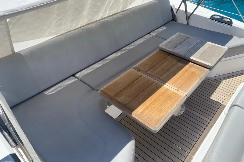  Yacht Photos Pics Luxurious seating area on 2019 Sunseeker Manhattan 66 yacht with wooden table.