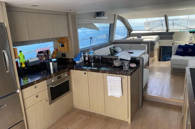  Yacht Photos Pics Luxurious interior of 2019 Sunseeker Manhattan 66 yacht with modern kitchen and seating area.