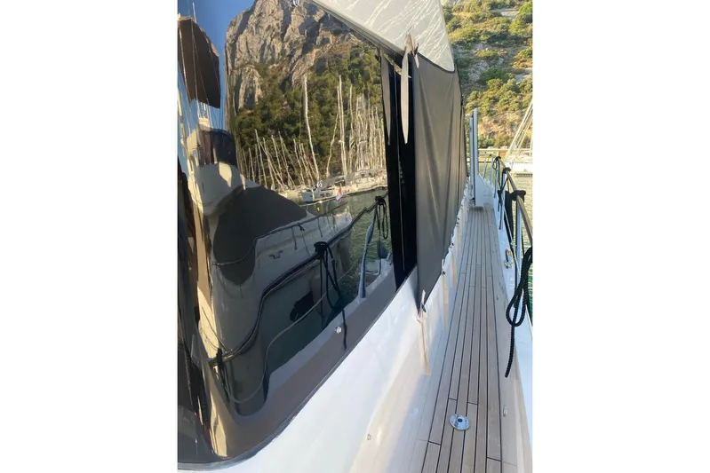  Yacht Photos Pics 2019 Sunseeker Manhattan 66 yacht with sleek design and scenic mountain reflection.
