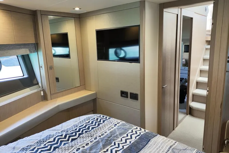  Yacht Photos Pics Luxurious interior of 2019 Sunseeker Manhattan 66 yacht bedroom with modern decor.