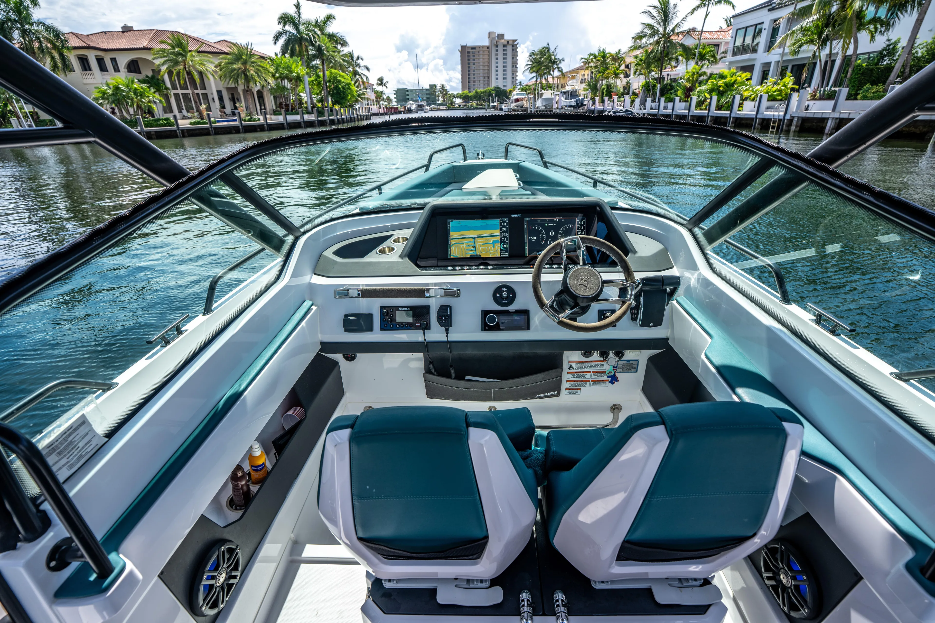 Yacht Photos Pics 2023 Axopar 28 T-Top boat cockpit with modern controls and waterfront view.