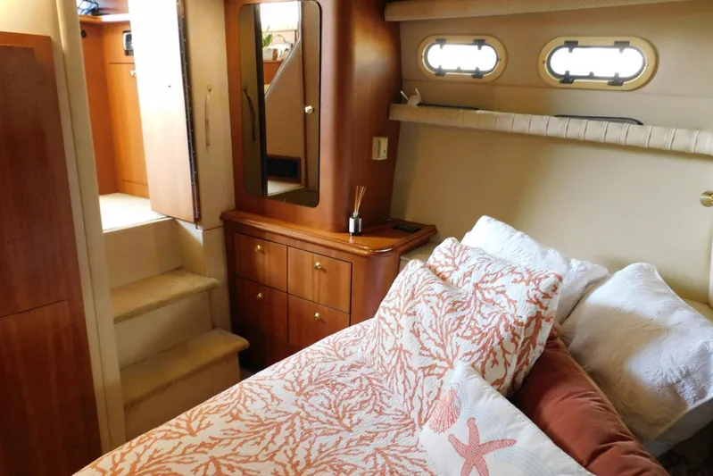 How Lucky Yacht Photos Pics Luxurious 2003 Cruisers Yachts 3750 Motoryacht cabin with elegant bedding and wooden cabinetry.