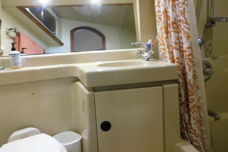How Lucky Yacht Photos Pics Bathroom interior of 2003 Cruisers Yachts 3750 Motoryacht with sink and shower curtain.