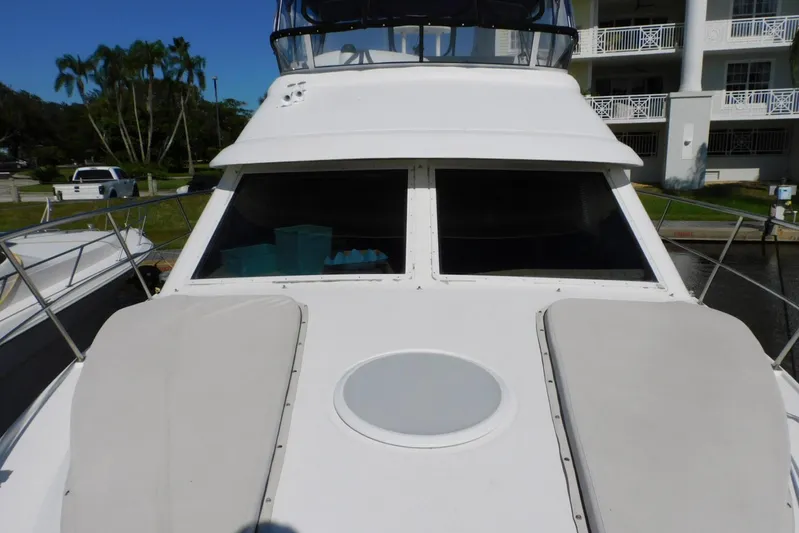 How Lucky Yacht Photos Pics 2003 Cruisers Yachts 3750 Motoryacht, docked with sunpads and clear windows.