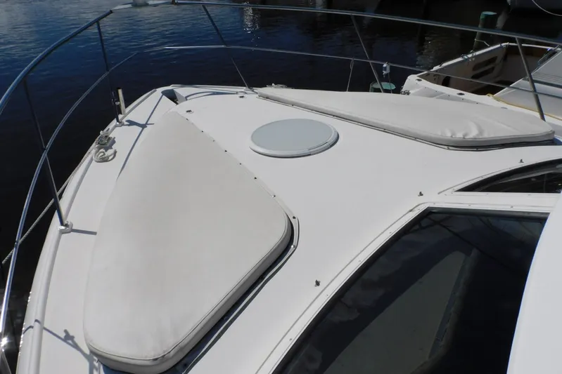 How Lucky Yacht Photos Pics 2003 Cruisers Yachts 3750 Motoryacht deck with sunpads and railing.