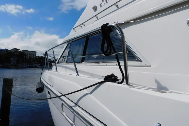 How Lucky Yacht Photos Pics 2003 Cruisers Yachts 3750 Motoryacht docked, showcasing sleek design and railing details.