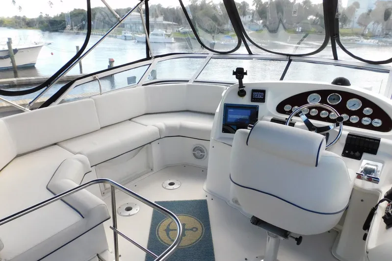 How Lucky Yacht Photos Pics 2003 Cruisers Yachts 3750 Motoryacht helm with white seating and navigational controls.