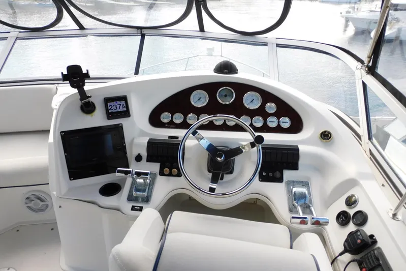 How Lucky Yacht Photos Pics 2003 Cruisers Yachts 3750 Motoryacht helm with steering wheel and control panel.