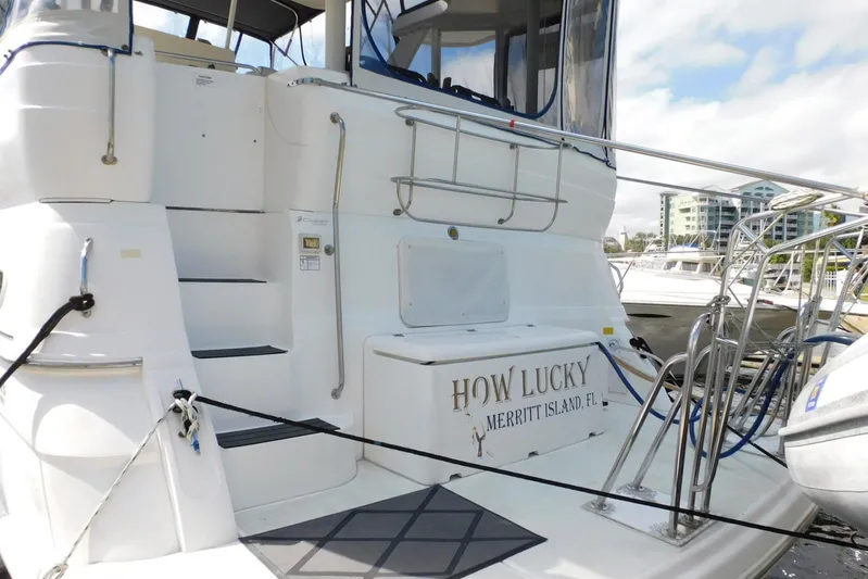 How Lucky Yacht Photos Pics 2003 Cruisers Yachts 3750 Motoryacht docked, featuring "How Lucky" nameplate.