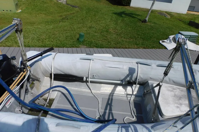 How Lucky Yacht Photos Pics 2003 Cruisers Yachts 3750 Motoryacht inflatable boat on deck, with ropes and equipment.