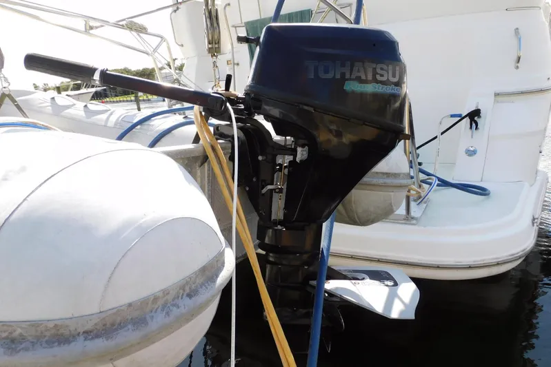 How Lucky Yacht Photos Pics Tohatsu outboard motor on 2003 Cruisers Yachts 3750 Motoryacht, docked with inflatable boat.