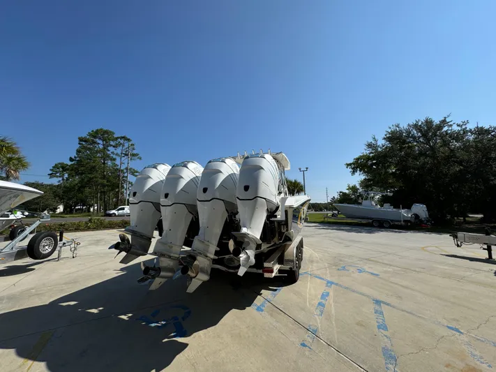  Yacht Photos Pics 2009 Fountain 38 CC Tournament Edition boat with multiple outboard engines in a sunny parking lot.