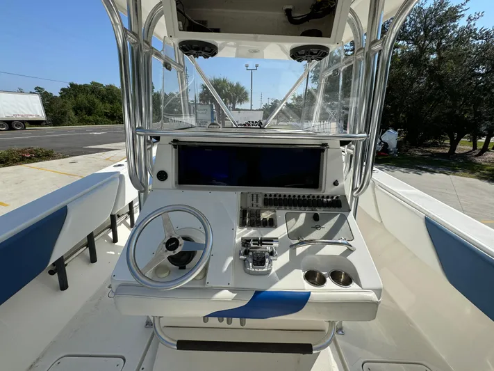  Yacht Photos Pics 2009 Fountain 38 CC Tournament Edition boat console with steering wheel and controls.