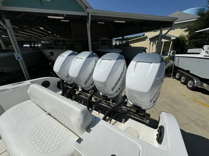  Yacht Photos Pics 2009 Fountain 38 CC Tournament Edition with four powerful outboard engines, docked in a marina.