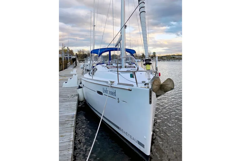 Unfettered Yacht Photos Pics 2011 Beneteau 40 sailboat docked at marina under cloudy sky.