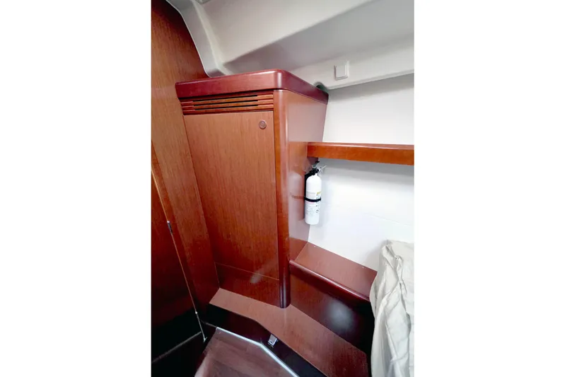 Unfettered Yacht Photos Pics Interior of 2011 Beneteau 40 yacht with wooden cabinetry and fire extinguisher.