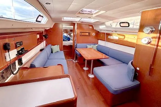 Unfettered Yacht Photos Pics Interior of 2011 Beneteau Oceanis 40 sailboat with cozy seating and wooden finishes.