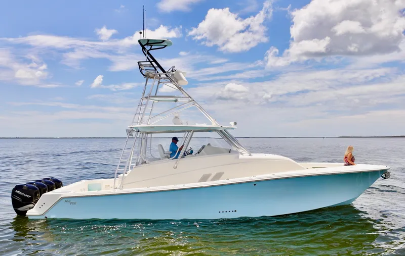 Saltwater Striker Yacht Photos Pics 2016 SeaVee 430 Fish Around boat on calm water under a partly cloudy sky.