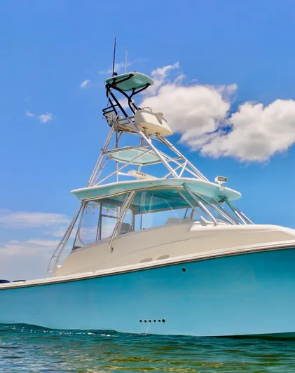 Saltwater Striker Yacht Photos Pics 2016 SeaVee 430 Fish Around boat on clear water under blue sky.