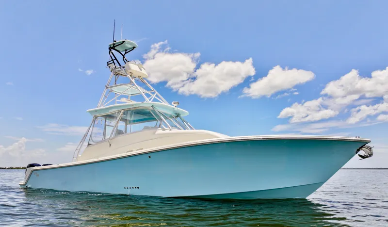Saltwater Striker Yacht Photos Pics 2016 SeaVee 430 Fish Around boat on calm water under blue sky.